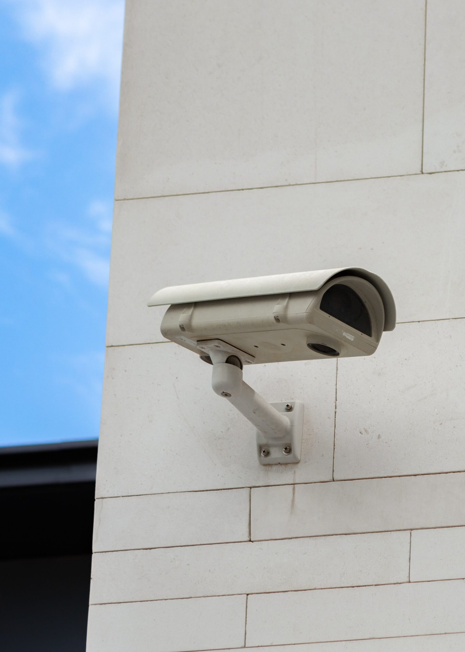 surveillance camera built into the stone wall of the building